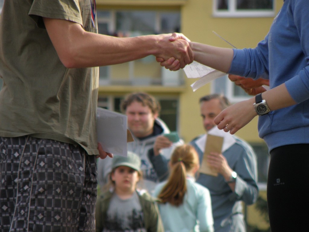 People shaking hands at end of public debate