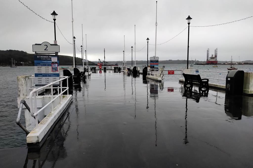 The pier in Falmouth on a wet day with a reflection