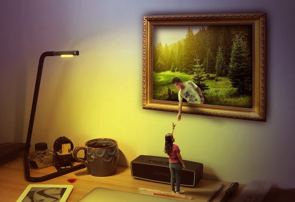 A woman reaches her hand towards a man inside the picture frame