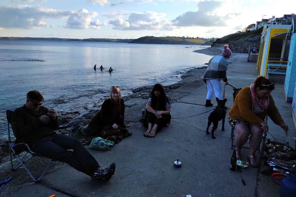 A party of revelling by beach hut on Castle Beach